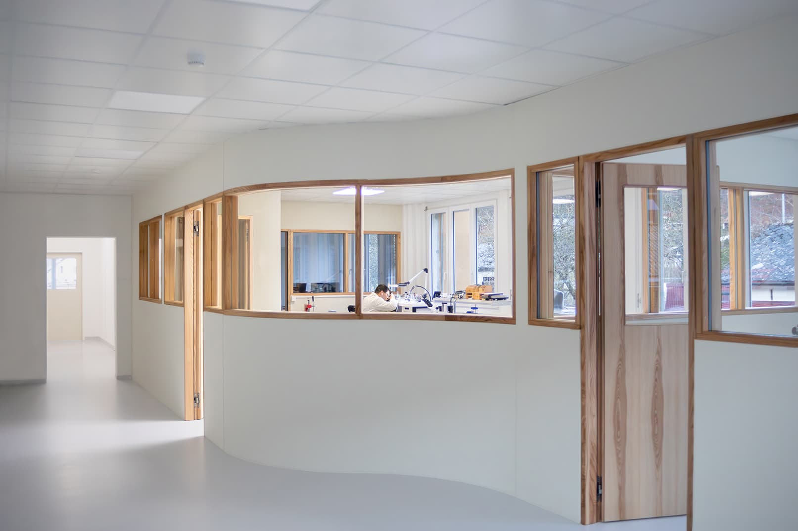 Watchmaker inspecting component with loupe