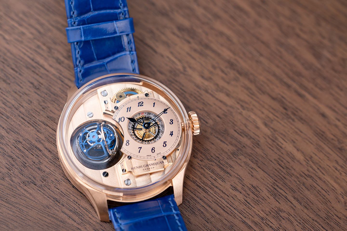 Rose gold dial close-up with blue indexes